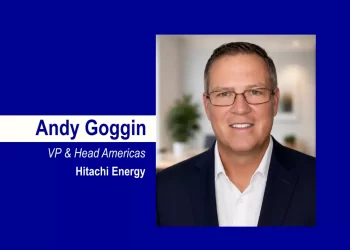 Portrait of Andy Goggin, VP & Head Americas at Hitachi Energy, on a royal blue background with a white name strip.