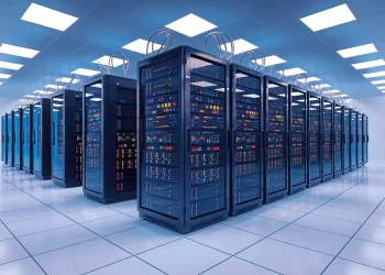 Data center with multiple server racks in a bright, tiled-floor room.