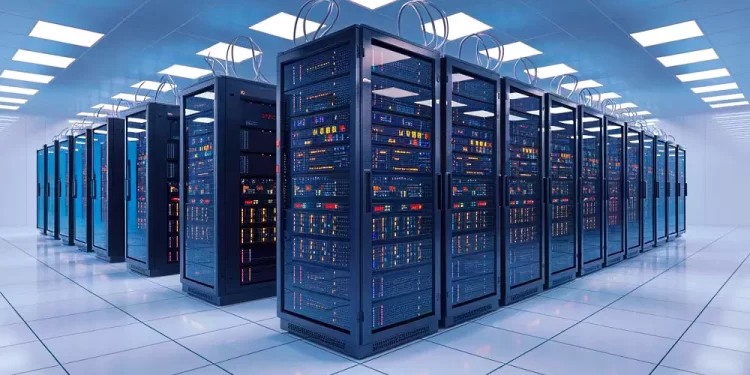 Data center with multiple server racks in a bright, tiled-floor room.