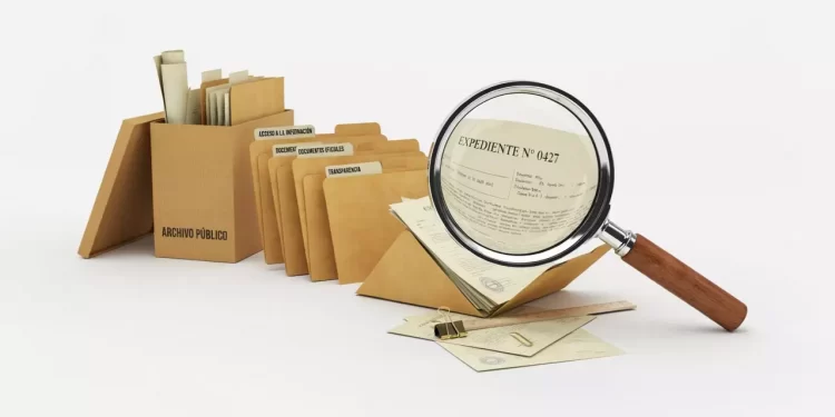 Row of tan archival folders with labeled dividers, a magnifying glass examines a document, plus scattered envelopes and clips.